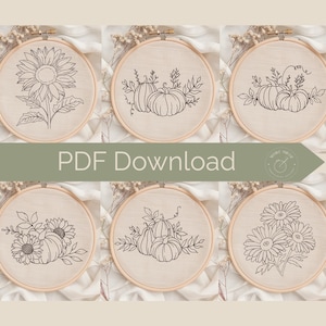May include: Six embroidery hoops with floral and pumpkin designs. Each hoop features a different black line drawing of a sunflower, pumpkins, or daisies on a beige fabric. The text "PDF Download" is displayed across the center of the image.