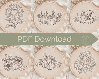 May include: Six embroidery hoops with floral and pumpkin designs. Each hoop features a different black line drawing of a sunflower, pumpkins, or daisies on a beige fabric. The text "PDF Download" is displayed across the center of the image.