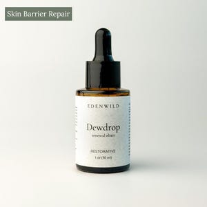 May include: A brown glass bottle with a black dropper top. The label reads "Edenwild Dewdrop renewal elixir RESTORATIVE 1 oz (30 ml)". The text "Skin Barrier Repair" is in a green rectangle in the upper left corner. The bottle is on a white background.