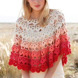 May include: A crocheted poncho in a gradient of colors, transitioning from cream at the top to coral and then red at the bottom. The openwork design features a scalloped edge and a round neckline, perfect for layering.