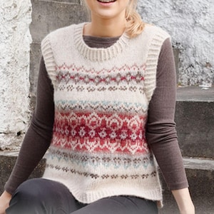 May include: A cream-colored knitted vest with a round neckline and a patterned design in red, brown, and blue. The sleeveless sweater features a fair isle pattern and is made of a soft, textured yarn. The vest is a cozy layering piece.