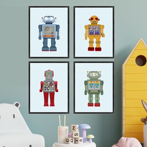 May include: Four framed robot art prints. Each robot is a different color: blue, yellow, red, and green. The robots have various details, including antennas, gauges, and rectangular bodies. The prints are displayed in a child's room.