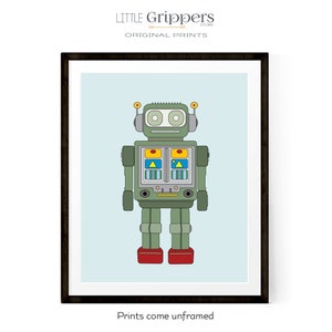 May include: A framed print featuring a retro-style robot illustration. The robot is primarily green with red feet, yellow and blue accents, and a light blue background. The text "LITTLE Grippers STORE ORIGINAL PRINTS" is at the top, and "Prints come unframed" at the bottom.