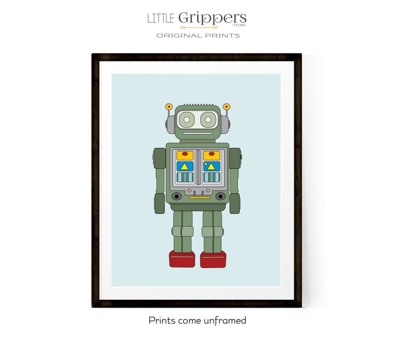 May include: A framed print featuring a retro-style robot illustration. The robot is primarily green with red feet, yellow and blue accents, and a light blue background. The text "LITTLE Grippers STORE ORIGINAL PRINTS" is at the top, and "Prints come unframed" at the bottom.