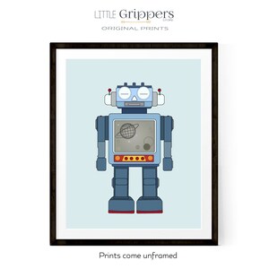 May include: Framed print featuring a blue robot illustration with a screen displaying a planet and stars. The robot has red accents and is set against a light blue background. The text "LITTLE GRIPPERS STORE ORIGINAL PRINTS" is at the top. The text "Prints come unframed" is at the bottom.