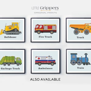 May include: Six framed prints featuring colorful illustrations of vehicles: a yellow bulldozer, a red fire truck, an orange truck, a green garbage truck, a white ambulance, and a blue train. The text "LITTLE Grippers STORE ORIGINAL PRINTS" is at the top.