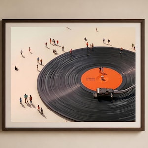May include: A framed art print featuring a large black vinyl record with an orange center label. Miniature figures are scattered around the record, creating a surreal scene. The record player needle is in place, and the artwork is set against a light background.