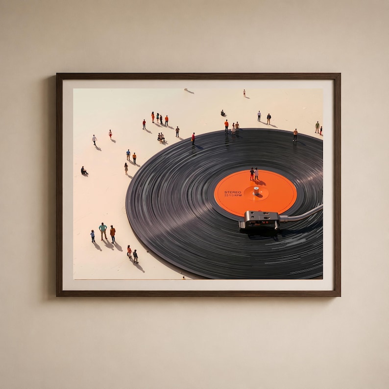 May include: A framed art print featuring a large black vinyl record with an orange center label. Miniature figures are scattered around the record, creating a surreal scene. The record player needle is in place, and the artwork is set against a light background.