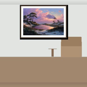 May include: A framed landscape painting showing a tranquil coastal scene. The artwork features a body of water reflecting a vibrant sunset with pink and purple hues. Trees and sand dunes are visible.