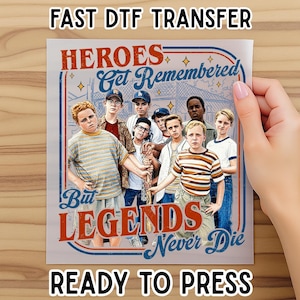 May include: A DTF transfer featuring a group of boys with the text "HEROES Get Remembered But LEGENDS Never Die". The image has a vintage aesthetic with a red, blue, and white color scheme. The words "FAST DTF TRANSFER" and "READY TO PRESS" are also visible.