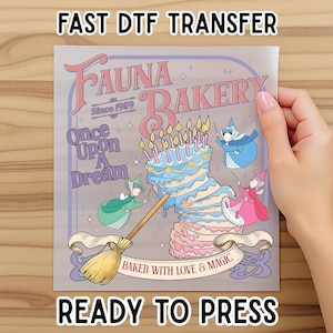 May include: A DTF transfer featuring a whimsical design for a bakery. The design includes a multi-layered cake with candles, fairies, and the text "Fauna Bakery" and "Once Upon A Dream". The words "Ready to Press" are also visible.