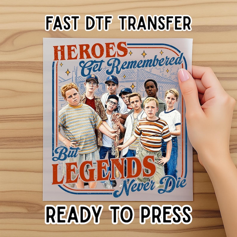 May include: A DTF transfer featuring a group of boys with the text "HEROES Get Remembered But LEGENDS Never Die". The image has a vintage aesthetic with a red, blue, and white colour scheme. The words "FAST DTF TRANSFER" and "READY TO PRESS" are also visible.