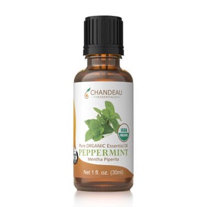 May include: A brown glass bottle of Chandeau Essentials peppermint essential oil. The label features a sprig of green mint and the text "PEPPERMINT" and "Net 1 fl. oz. (30ml)". The bottle has a black cap and is USDA organic certified.