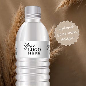 May include: A clear plastic water bottle with a white label featuring the black text Your LOGO HERE. A beige starburst shape contains the white text Upload your own design! The bottle has a ribbed body and a matching white screw-on cap.