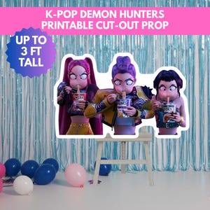 May include: A printable cut-out prop featuring three K-Pop Demon Hunters eating noodles. The prop is up to 91 cm tall and includes the names Mira, Rumi, and Zoey on the noodle cups. The background is a light blue curtain.