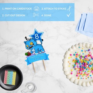 May include: A birthday cake with white frosting and colorful sprinkles. A blue cake topper with a cartoon tiger and the text "Happy Birthday Ryan" is placed on top. Other items include candles, a plate, and instructions.