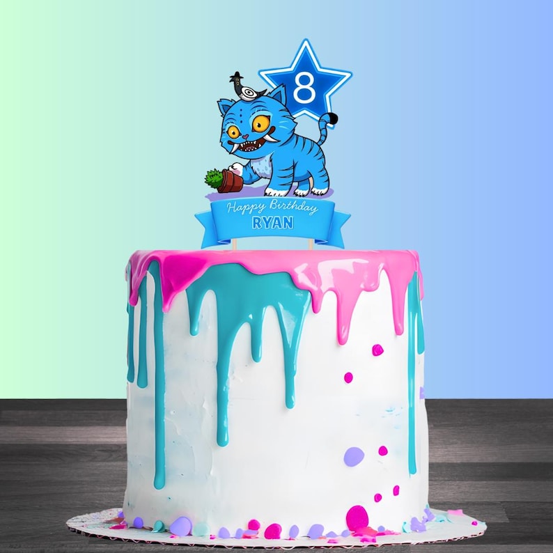May include: A white birthday cake with pink and teal frosting drips. The cake is decorated with a blue cartoon tiger cake topper holding a small plant, a blue star with the number 8, and a banner that reads "Happy Birthday RYAN."