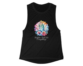 May include: Black sleeveless top featuring a colorful floral design with praying hands at the center. The design includes pink, blue, and yellow flowers, with the text "PRAYER CHANGES Everything" in white.