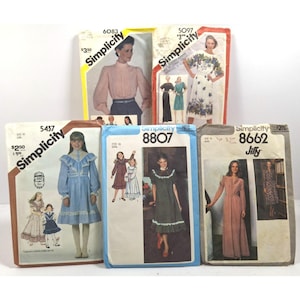 May include: A selection of vintage Simplicity sewing patterns. The patterns showcase illustrations of dresses and blouses, with prices and pattern numbers visible. The colour palette includes shades of blue, pink, and white, with the Simplicity logo displayed.