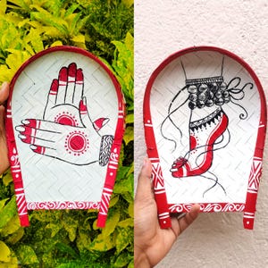 May include: Two hand-painted, arched bamboo trays. One features a red and white hand design with henna-style patterns. The other depicts a foot with anklets and henna-style designs. Both have red borders and decorative patterns.