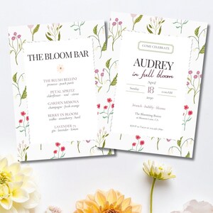 May include: Two white cards with floral designs. One card reads "The Bloom Bar" with a drink menu. The other card says "Audrey in full bloom" with event details. Both cards have a floral border with pink and red flowers.