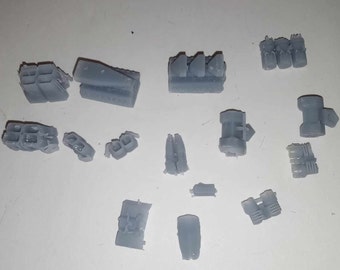 May include: A collection of 14 gray 3D printed plastic parts. The parts are various shapes and sizes, some are rectangular, some are round, and some are more complex.