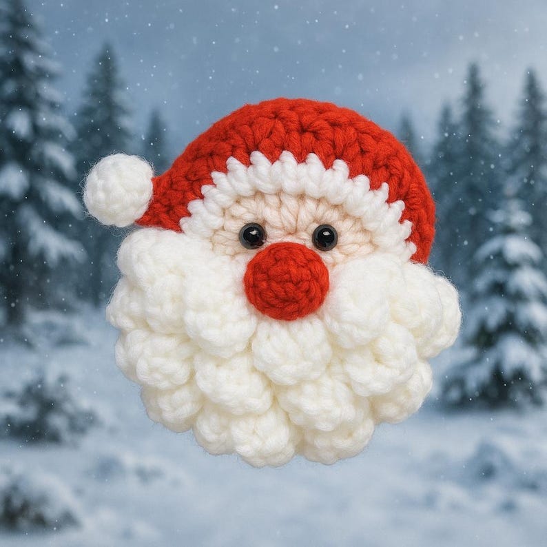 May include: A crocheted Santa Claus face with a red hat and nose, white beard, and black eyes. The Santa Claus face is a handmade item, perfect for Christmas decorations. The background features a snowy forest scene.
