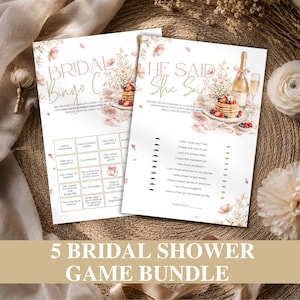May include: Two white paper bridal shower game cards featuring floral illustrations, a champagne bottle, and a stack of pancakes. One card is titled Bridal Bingo Card and the other He Said She Said, both containing text instructions and game grids.
