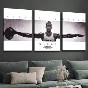 May include: Triptych wall art featuring Michael Jordan in a black and white photograph. The artwork is divided into three panels, with the name "MICHAEL JORDAN" printed across the top. The center panel includes the word "WINGS" and a quote.