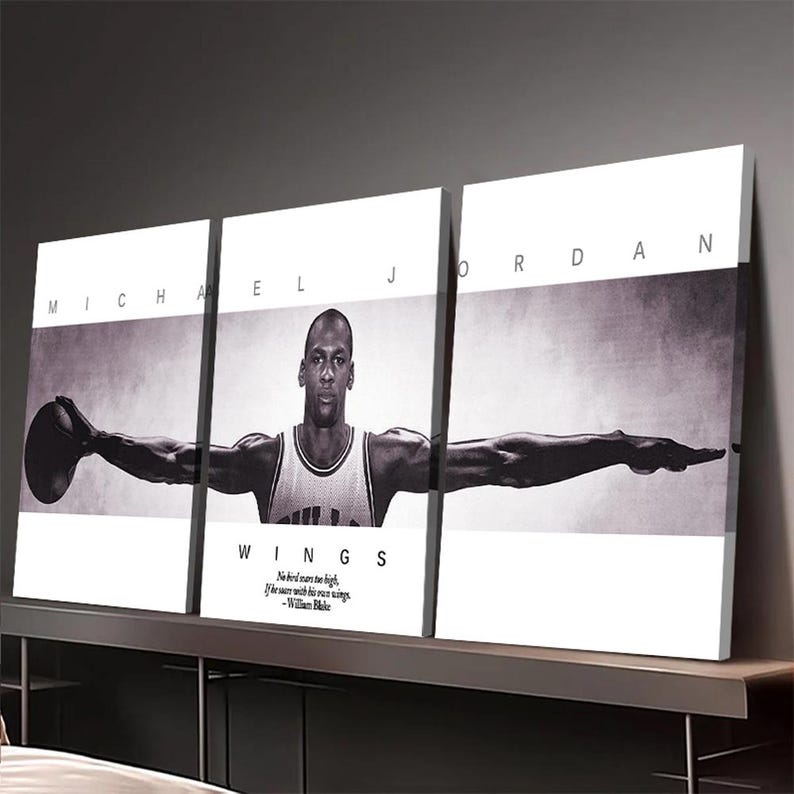 May include: A triptych canvas print featuring a black and white image of Michael Jordan. The artwork displays Jordan with outstretched arms, holding a basketball. The text "MICHAEL J JORDAN" is at the top, and "WINGS" with a quote by William Blake is at the bottom.