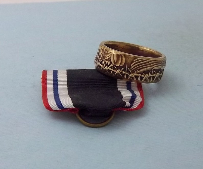 This is a POW Prisoner of War Service medal turned into a size 10 12 ring Wear this on your special occasions.