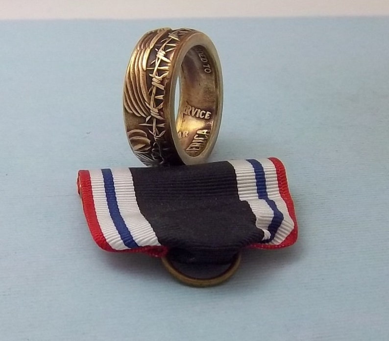 This is a POW Prisoner of War Service medal turned into a size 10 12 ring Wear this on your special occasions.