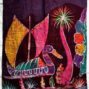 May include: A batik textile depicting a boat, palm tree, and figures in vivid colours. The boat has yellow and pink sails, set against a dark purple backdrop. The artwork uses green, orange, and purple, creating a striking visual effect.