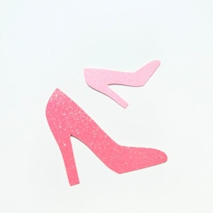 May include: Pink glitter high heel shoe confetti. The confetti is in the shape of a high heel shoe.