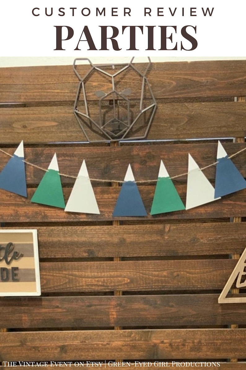 May include: A wooden backdrop with a geometric bear silhouette, a string of blue, green, and white triangle pennants, and a sign that says "Little Dude".