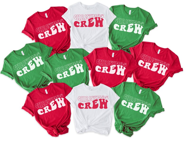 May include: A selection of red, white, and green t-shirts. Each shirt features the text "CHRISTMAS CREW" in a retro style. The short-sleeved shirts are likely made from a soft fabric, suitable for festive occasions.