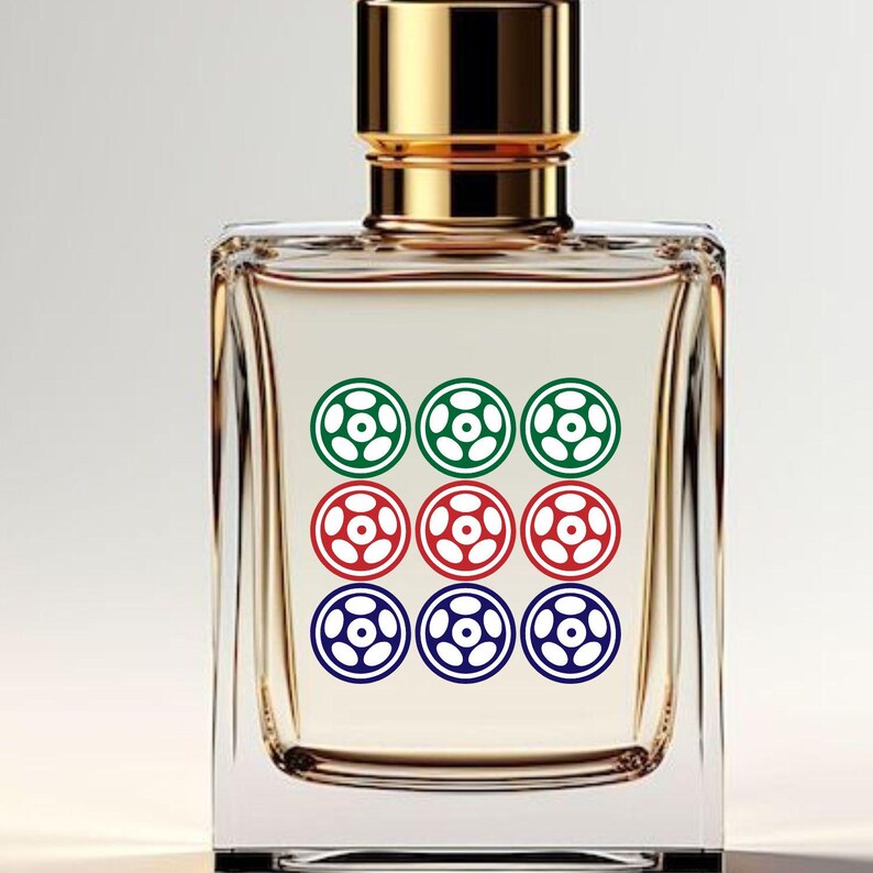 May include: A clear, rectangular perfume bottle with a gold cap. The bottle's label features a pattern of nine circular designs in green, red, and blue. The perfume inside has a light amber hue.