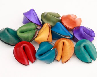 May include: A collection of colorful leather fortune cookies. The cookies are in various shades of green, blue, red, orange, yellow, and purple.