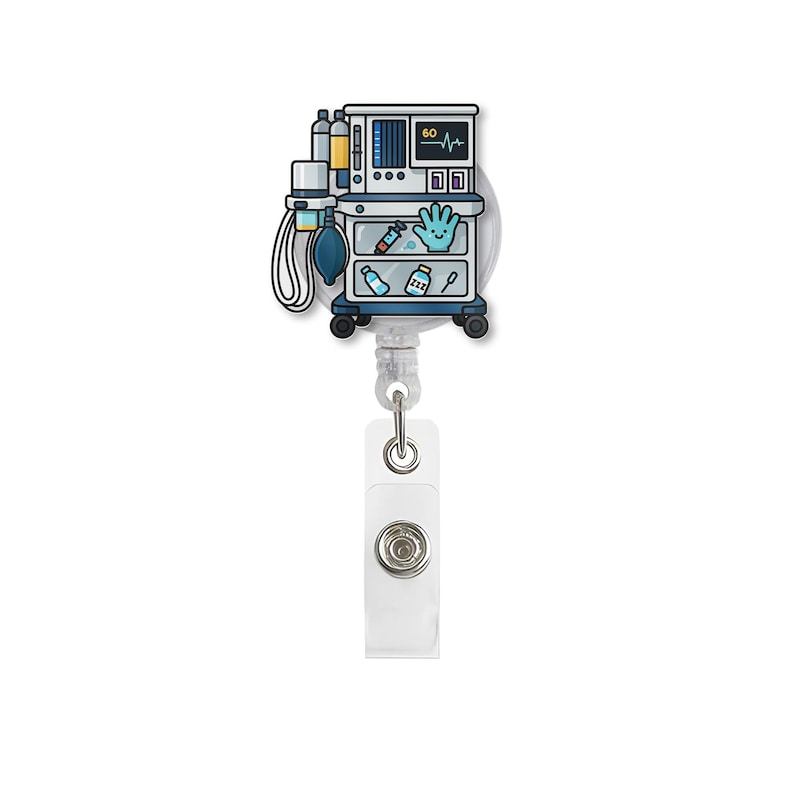 May include: A medical-themed retractable badge reel featuring a cartoon illustration of an anesthesia machine. The design includes a monitor displaying a heartbeat, a blue oxygen bag, and various medical supplies. The reel has a white clip and a silver retractable cord.