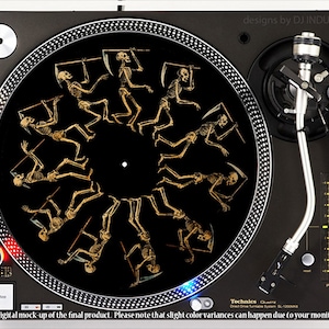 May include: A black turntable with a gold skeleton design on the platter. The turntable is a Technics Direct Drive Turntable System SL-1200MK2.