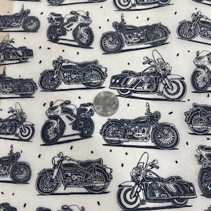 May include: A white fabric with a repeating pattern of black and white motorcycle illustrations. The motorcycles are all different styles and sizes, and some have sidecars.