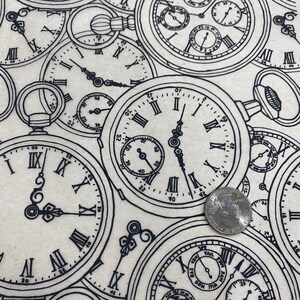 May include: A beige fabric with a repeating pattern of black and white pocket watches. The watches have Roman numeral markings and are in various sizes and positions.