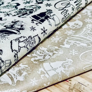 May include: Two sheets of wrapping paper with a Christmas theme. One sheet is white with black illustrations of people and snowflakes. The other sheet is brown with white illustrations of people and snowflakes. The text "Merry Christmas" is printed on the white sheet.