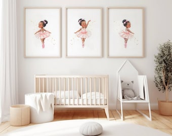 May include: Three framed watercolor prints of young ballerinas in pink tutus and ballet shoes. The prints are displayed above a light wood crib in a bright, airy nursery setting. A white storage bin and a woven basket are also visible.