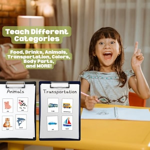 May include: A young girl sits at a yellow table with two clipboards displaying educational images. One clipboard says "Animals" with pictures of a pig, cow, tiger, and shark. The other says "Transportation" with images of a train, school bus, car, and boat. Text above reads "Teach Different Categories".