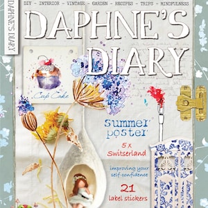 May include: The cover of Daphne's Diary magazine features a watercolor illustration with the title in large white letters. The cover includes a cupcake illustration, a fairy in a hanging pod, and text that reads "Summer Poster" and "21 Label stickers."