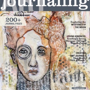 May include: The cover of "Art Journaling" magazine features an abstract portrait with a neutral color palette. The title is in large white letters. Text includes "200+ Journal Pages" and articles about kindness and tiny journals.