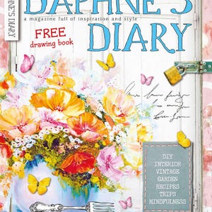 May include: The cover of "Daphne's Diary" magazine features a floral arrangement in a blue vase, with butterflies and silverware. The magazine title is in large, blue, stylized letters. The cover also includes the text "FREE drawing book".