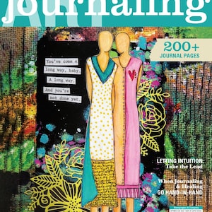 May include: Art Journaling magazine cover with the title in large teal letters. The cover features two stylized figures in dresses, one white with yellow polka dots and the other pink. Text includes "200+ Journal Pages" and "Expressing Gratitude Through a Junk Journal."