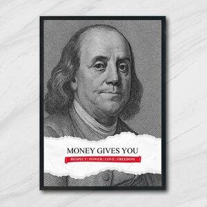 May include: Black framed print featuring a grayscale portrait of Benjamin Franklin. A white, torn paper effect across the bottom displays the text "MONEY GIVES YOU" above a red banner with the words "RESPECT | POWER | LOVE | FREEDOM".